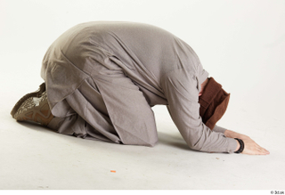 Luis Donovan Afgan Civil Praying kneeling praying whole body 0007.jpg